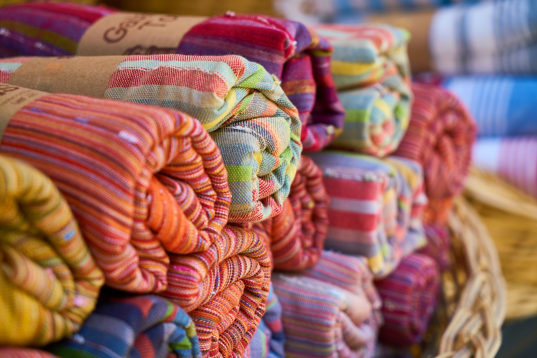 Rolls of colourful woven fabric